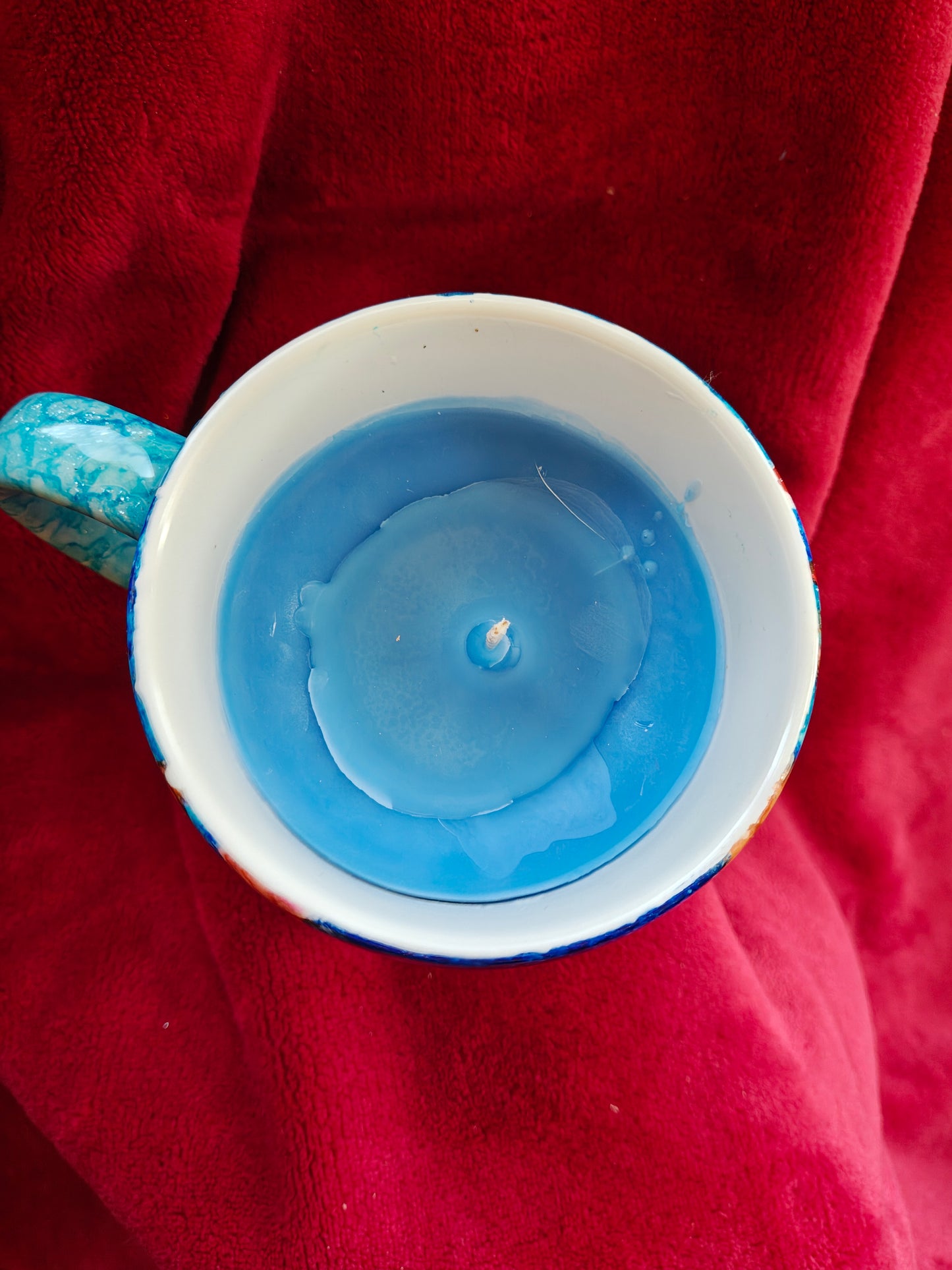 16oz ceramic coffee mug with blue candle